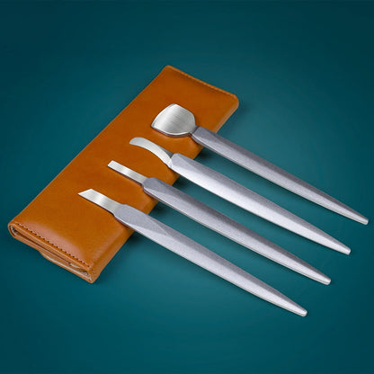 Set of stainless steel manicure tools with brown case on blue background